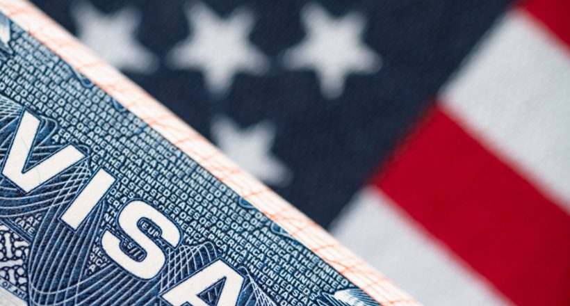 VISA to the USA and the flag of the United States of America. work and travel documents for visiting the USA. Visa for immigration